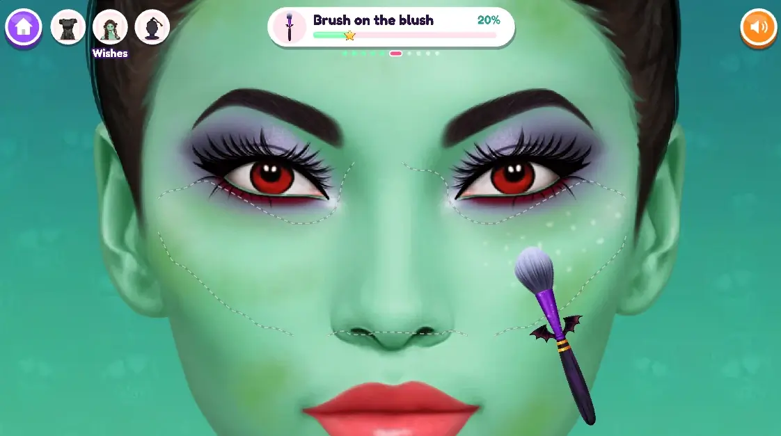Green face with dashed cheek guides while a bat-handled brush applies blush